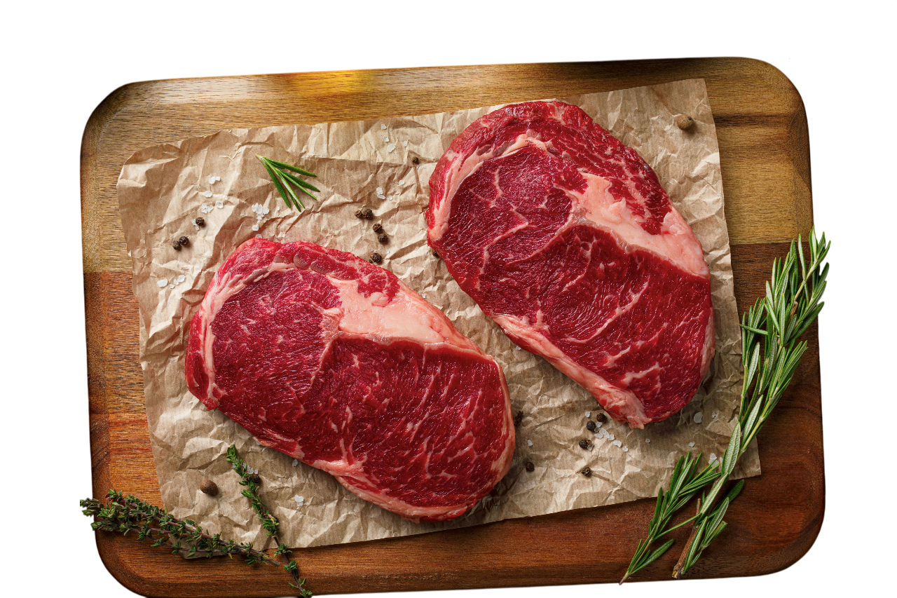 Steaks de viande sur plateau en bois avec herbes et épices